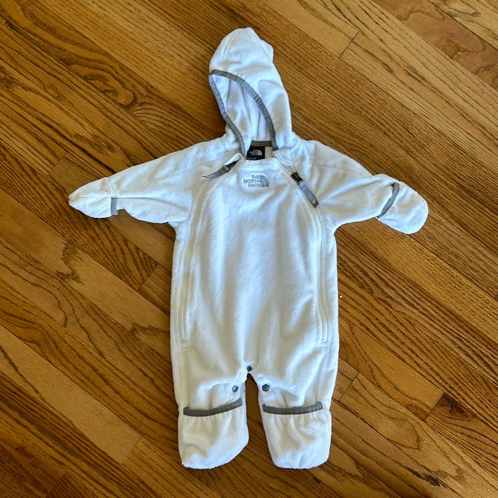 The North Face White fleece suit for an infant. Zippers on both sides.